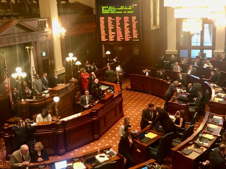 Gov. Pritzker lobbies on the House floor before the vote on the minimum wage. (Twitter/Andrea Kluger)