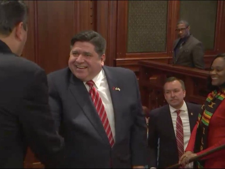 Gov. Pritzker shakes hands with members of the General Assembly leading him into the Capitol for his budget address. (Illinois.gov)