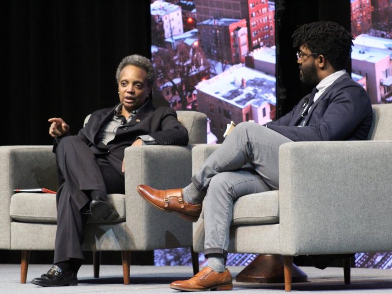 Chicago Mayor Lori Lightfoot talks with City Bureau founder Darryl Holliday during the Solutions Toward Ending Poverty Summit. (One Illinois/Ted Cox)